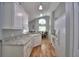 Bright kitchen with white cabinets, granite countertops and hardwood floors, leading into the dining area at 2350 Paulette Dr, Haines City, FL 33844