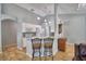 Open kitchen layout with white cabinets, breakfast bar with seating, and granite countertops at 2350 Paulette Dr, Haines City, FL 33844