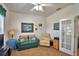 Comfortable office or den featuring a cozy couch and serene golf course artwork at 2350 Paulette Dr, Haines City, FL 33844
