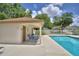 Community pool area with lounge chairs and a covered patio offering a relaxing recreational space at 2350 Paulette Dr, Haines City, FL 33844