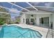 View of the screened-in pool and lanai with sliding doors to the home's interior at 2350 Paulette Dr, Haines City, FL 33844