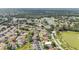 Aerial view of a residential area featuring tree-lined streets and community ponds surrounded by lush greenery at 2602 Whitewood Rd, Mulberry, FL 33860