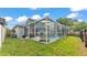 The backyard features a screened-in pool, creating a private oasis for relaxing and entertaining outdoors at 2602 Whitewood Rd, Mulberry, FL 33860