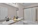 Bathroom showcasing double sinks, bathtub, and shower combination with a white shower curtain at 2602 Whitewood Rd, Mulberry, FL 33860