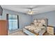 Comfortable bedroom featuring a ceiling fan, neutral paint and large window with natural light at 2602 Whitewood Rd, Mulberry, FL 33860