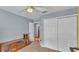 Brightly lit bedroom featuring closet space and blue accent wall at 2602 Whitewood Rd, Mulberry, FL 33860
