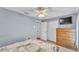 A well-lit bedroom with a ceiling fan, closet, and en-suite bathroom at 2602 Whitewood Rd, Mulberry, FL 33860