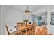 Well-lit dining room with wooden table set, open to the living spaces at 2602 Whitewood Rd, Mulberry, FL 33860