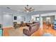 Open-concept living room with hardwood floors, comfortable seating, and a view of the dining area at 2602 Whitewood Rd, Mulberry, FL 33860