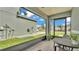 Outdoor view from a screened porch with chairs and a table for relaxed seating at 2602 Whitewood Rd, Mulberry, FL 33860