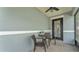 Cozy screened porch with a table and chairs, perfect for enjoying the outdoors at 2602 Whitewood Rd, Mulberry, FL 33860