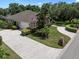 Stunning aerial view showcases the home's lush landscaping and brick-paved driveway at 2977 Sequoyah Dr, Haines City, FL 33844
