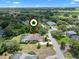 A serene aerial view of a home with a pool, landscaped yard, and elegant circular driveway at 2977 Sequoyah Dr, Haines City, FL 33844