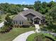 Expansive aerial view reveals the property's landscaped yard, stone accents and circular driveway at 2977 Sequoyah Dr, Haines City, FL 33844