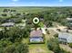 Aerial view of a home with a screened pool, situated on a lot with plenty of trees at 2977 Sequoyah Dr, Haines City, FL 33844