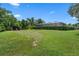 Spacious backyard featuring lush greenery and mature hedges for privacy at 2977 Sequoyah Dr, Haines City, FL 33844