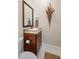 Half bath with granite vanity, stylish fixtures, and decorative wall hanging at 2977 Sequoyah Dr, Haines City, FL 33844