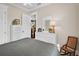 Bright bedroom featuring a white bed frame, ceiling fan, a dresser, and an open doorway at 2977 Sequoyah Dr, Haines City, FL 33844