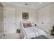 Bedroom with white wicker bed, patterned bedding, two closets, and neutral color scheme at 2977 Sequoyah Dr, Haines City, FL 33844