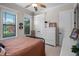Bedroom with a black metal bed frame, two windows and a large white dresser in a neutral color palette at 2977 Sequoyah Dr, Haines City, FL 33844
