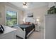 Bright bedroom with a white bed frame, ceiling fan, two side tables, neutral walls, and window at 2977 Sequoyah Dr, Haines City, FL 33844