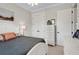 Bright bedroom featuring a white bed frame, ceiling fan, a dresser, and closet at 2977 Sequoyah Dr, Haines City, FL 33844