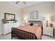 Bedroom featuring a black metal bed frame, ceiling fan, two side tables and neutral walls at 2977 Sequoyah Dr, Haines City, FL 33844