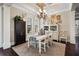 Bright dining room featuring elegant chandelier, built-in cabinet, and large windows at 2977 Sequoyah Dr, Haines City, FL 33844