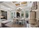 Open-concept dining room with chandelier, windows, and access to other living spaces at 2977 Sequoyah Dr, Haines City, FL 33844