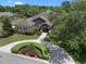 Aerial view of a home with a lush, manicured front yard and a brick driveway at 2977 Sequoyah Dr, Haines City, FL 33844