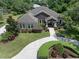 Aerial view of a beautiful single-story home with a well-manicured lawn and a paved driveway at 2977 Sequoyah Dr, Haines City, FL 33844
