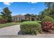 Charming single-story home with stone facade, brick-paved driveway, and lush landscaping at 2977 Sequoyah Dr, Haines City, FL 33844