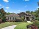 Beautiful single-story home with stone facade and well-manicured lawn offers great curb appeal at 2977 Sequoyah Dr, Haines City, FL 33844