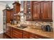 Well-equipped kitchen with stainless appliances, granite countertops, and wooden cabinets at 2977 Sequoyah Dr, Haines City, FL 33844