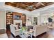 Open-concept living room with hardwood floors, built-in shelves, and fireplace at 2977 Sequoyah Dr, Haines City, FL 33844