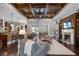 Inviting living room features a fireplace, hardwood floors, coffered ceiling, and seamless flow to outdoor living at 2977 Sequoyah Dr, Haines City, FL 33844