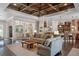Spacious living room featuring a coffered ceiling, hardwood floors, and an open floor plan to the kitchen at 2977 Sequoyah Dr, Haines City, FL 33844