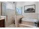 Spa-like main bathroom featuring a soaking tub, tiled shower, and elegant fixtures, designed for relaxation at 2977 Sequoyah Dr, Haines City, FL 33844