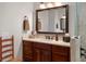 Elegant main bathroom with a dark wood vanity, decorative fixtures, and glass walk-in shower at 2977 Sequoyah Dr, Haines City, FL 33844