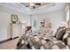 Charming main bedroom showcasing a quilt, sitting area, and tranquil atmosphere with light-colored furnishings at 2977 Sequoyah Dr, Haines City, FL 33844