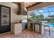Outdoor kitchen with stainless steel grill, stone hood, and a convenient mini-fridge at 2977 Sequoyah Dr, Haines City, FL 33844