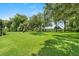 Expansive backyard with healthy green lawn and mature trees bordering the property at 2988 Sequoyah Dr, Haines City, FL 33844