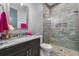 Bathroom with marble countertops and a glass shower with pebble floor at 2988 Sequoyah Dr, Haines City, FL 33844