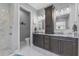 Chic bathroom features a double sink vanity, modern lighting and marble floors at 2988 Sequoyah Dr, Haines City, FL 33844