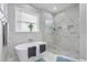 Gorgeous bathroom features a soaking tub and frameless glass walk-in shower at 2988 Sequoyah Dr, Haines City, FL 33844