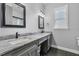 Bathroom with double vanity, granite countertop and black fixtures, offering ample counter space at 2988 Sequoyah Dr, Haines City, FL 33844