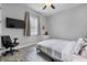 A cozy bedroom with a ceiling fan, TV, wood-look flooring, and a neutral color scheme at 2988 Sequoyah Dr, Haines City, FL 33844