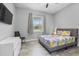 Bedroom with a ceiling fan, wood-look floors, and a view from the window at 2988 Sequoyah Dr, Haines City, FL 33844