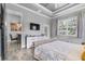 Serene bedroom with a neutral palette, TV, backyard views, and connecting door to the dining area at 2988 Sequoyah Dr, Haines City, FL 33844