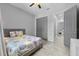 Bedroom with gray wood-look floors, grey doors, and a ceiling fan at 2988 Sequoyah Dr, Haines City, FL 33844